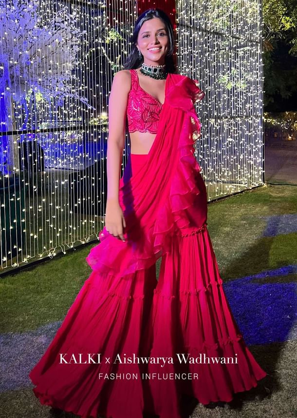 Hot Pink Crop Top Sharara Suit With An Attached Ruffle Draped And An Hand Embroidered Leaf Motifs