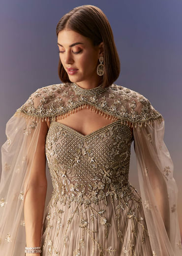 Beige Gown With Shoulder Cape And Rich Vertical Embroidery