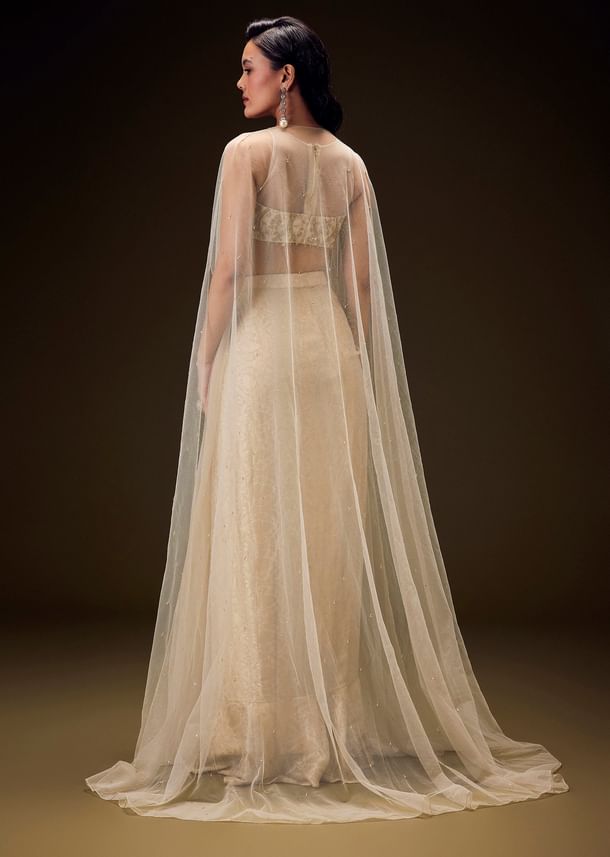 Beige Zardozi Embroidered Blouse With Brocade Drape Skirt And Net Cape