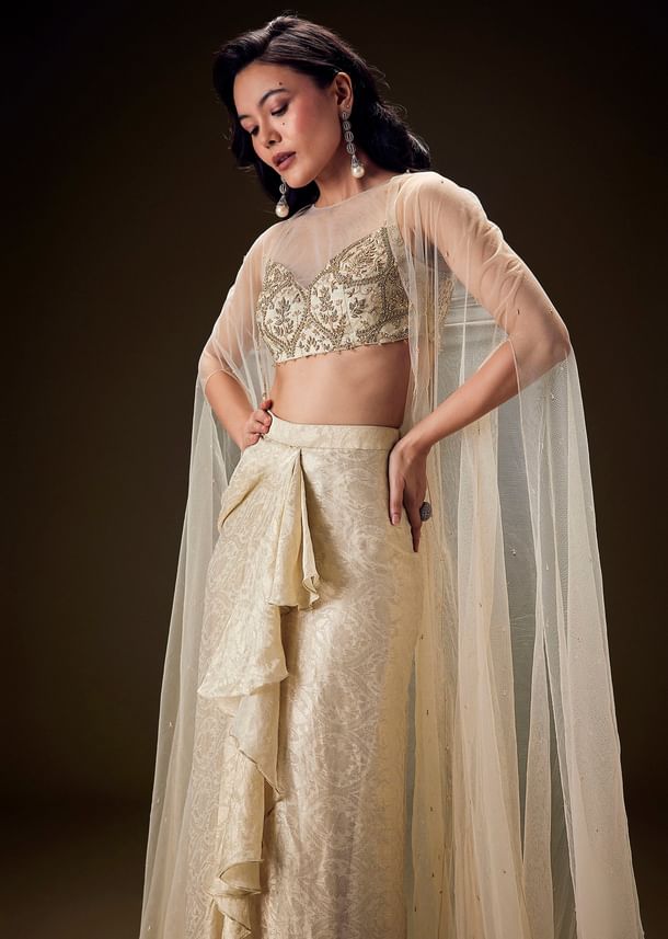 Beige Zardozi Embroidered Blouse With Brocade Drape Skirt And Net Cape