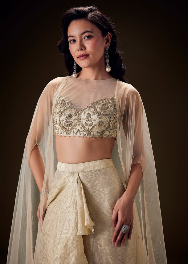 Beige Zardozi Embroidered Blouse With Brocade Drape Skirt And Net Cape