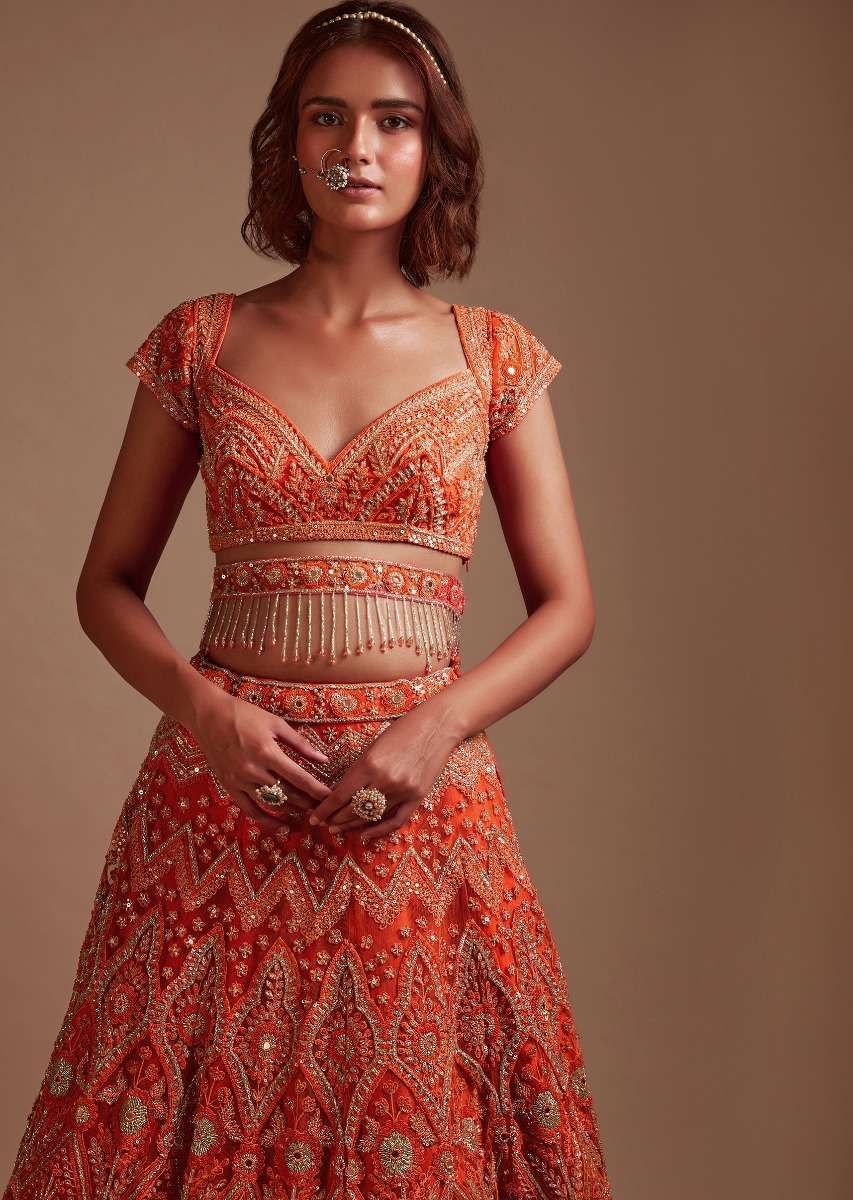 Coral Orange Lehenga Choli In Net With Mirror And Sequins Embroidered Floral And Mughal Embroidery Along With Belt Detailing