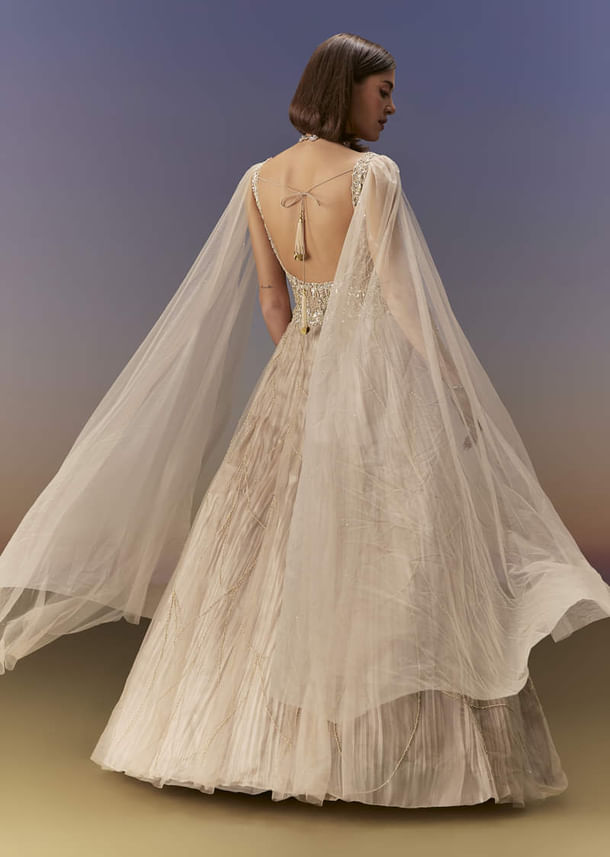 Gold Gown With Pleated Panels And Dramatic Cape Gold Gown With Pleated Panels And Dramatic Cape