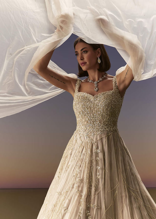 Gold Gown With Pleated Panels And Dramatic Cape Gold Gown With Pleated Panels And Dramatic Cape