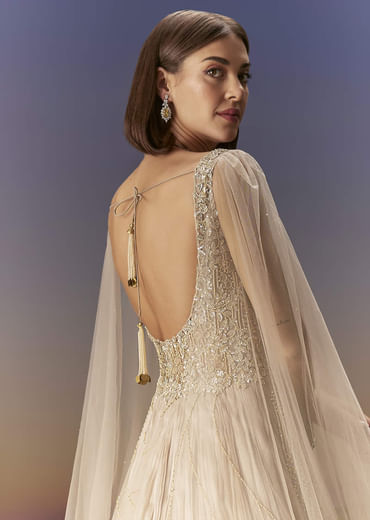 Gold Gown With Pleated Panels And Dramatic Cape