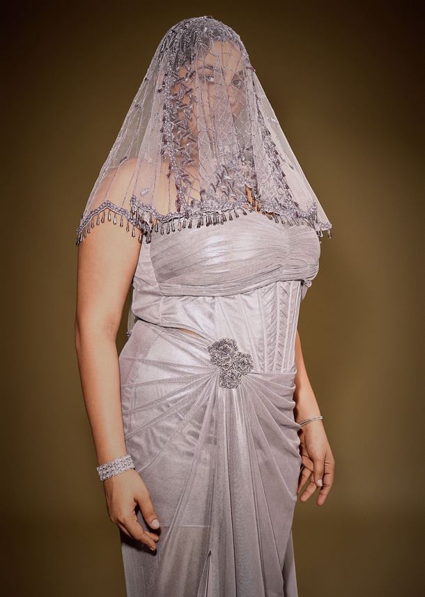 Gold One Shoulder Drape Gown With Embroidered Floral Brooch And Trail