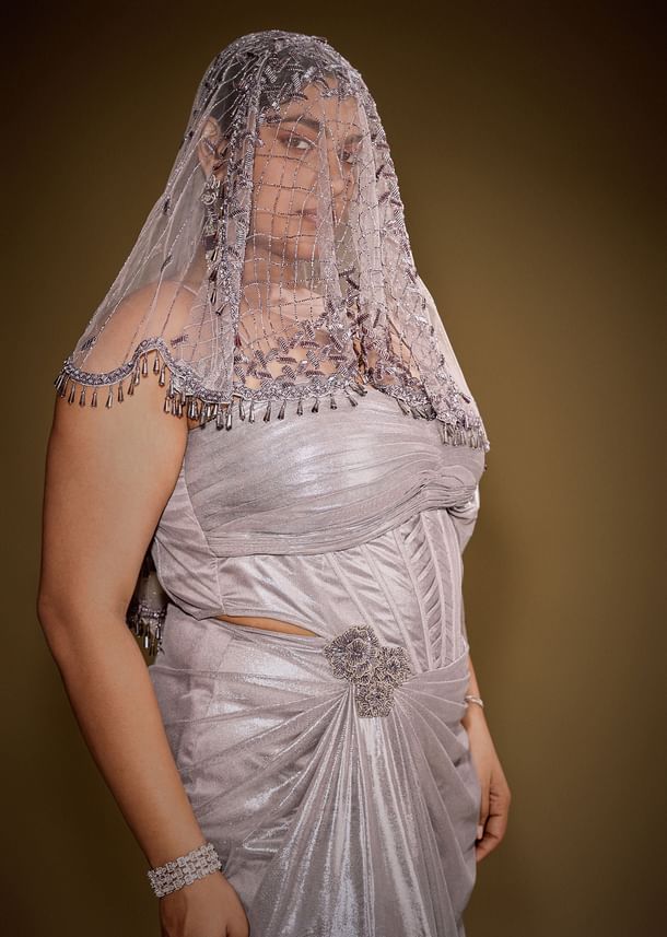 Gold One Shoulder Drape Gown With Embroidered Floral Brooch And Trail