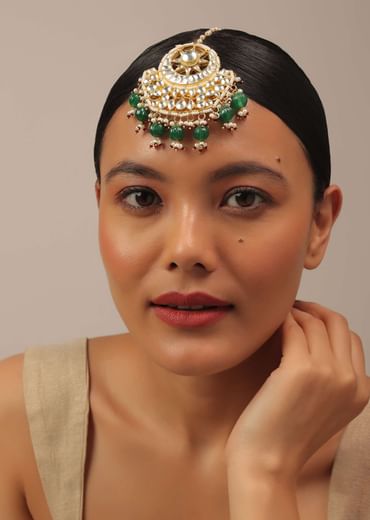Gold Finish Kundan Floral Maangtika With Synthetic Emerald Stones And Beads