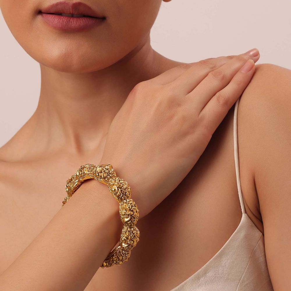 Gold Finish Temple Style Bangle With Carvings
