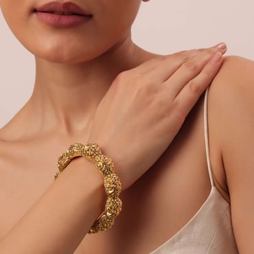 Gold Finish Temple Style Bangle With Carvings