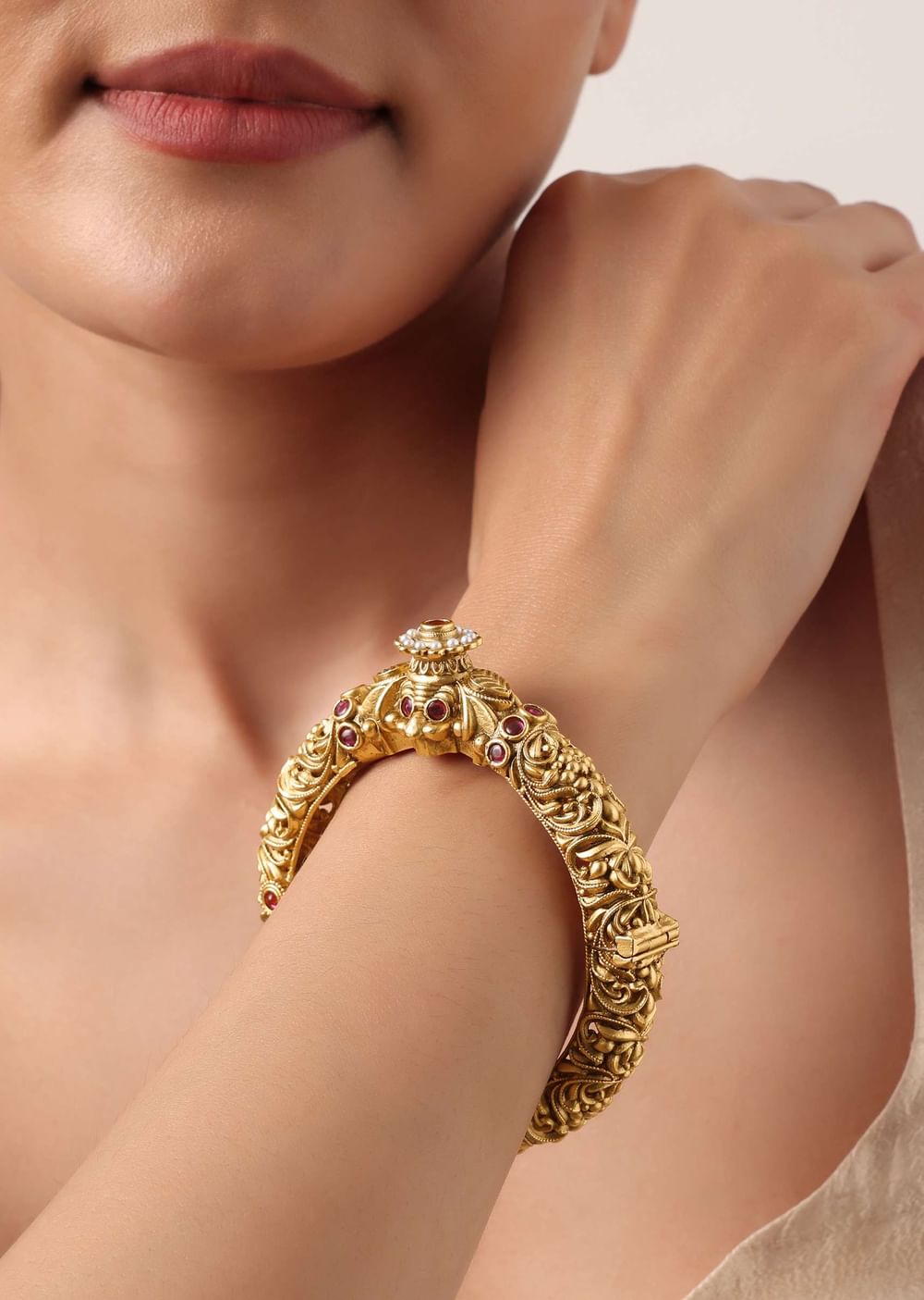 Gold Plated Temple Bangle With Carved Detail And Red Stones