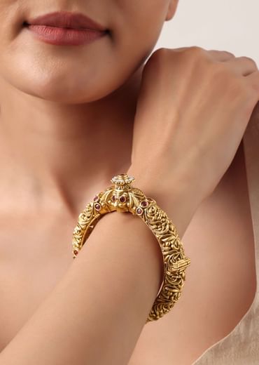 Gold Plated Temple Bangle With Carved Detail And Red Stones