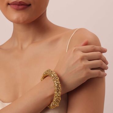 Gold Tone Temple Bangle With Carved Detail