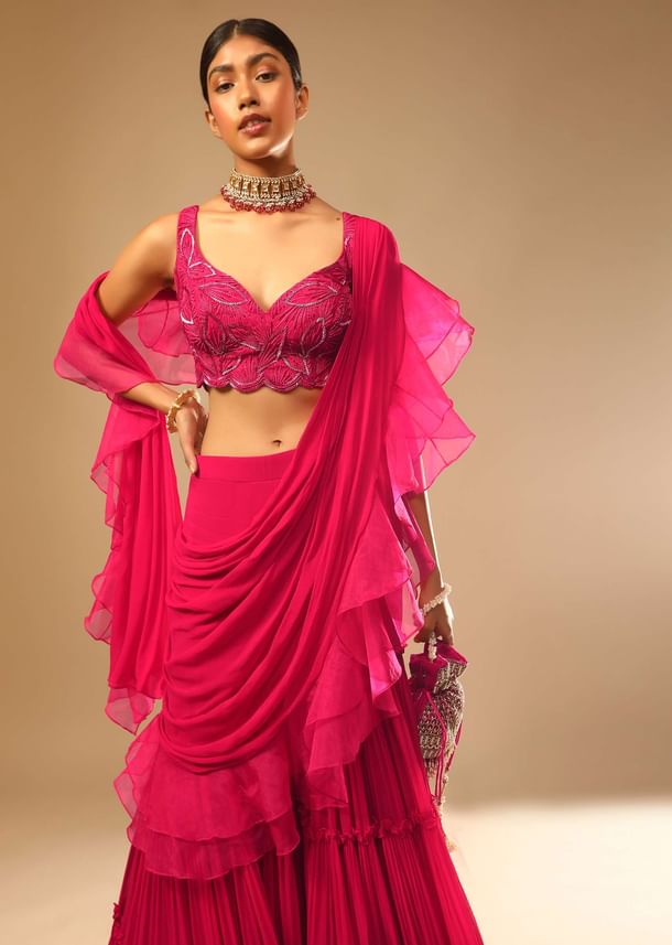 Hot Pink Crop Top Sharara Suit With An Attached Ruffle Draped And An Hand Embroidered Leaf Motifs