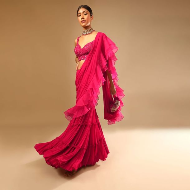 Hot Pink Crop Top Sharara Suit With An Attached Ruffle Draped And An Hand Embroidered Leaf Motifs