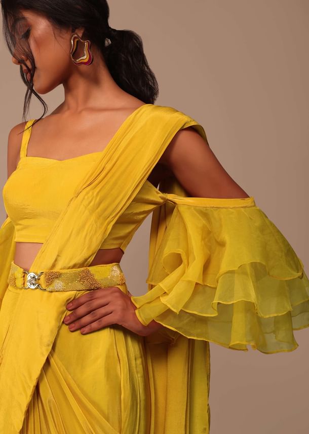 Mustard Yellow Crepe Saree With Ruffle Layered Blouse And Embroidered Belt Mustard Yellow Crepe Saree With Ruffle Layered Blouse And Embroidered Belt
