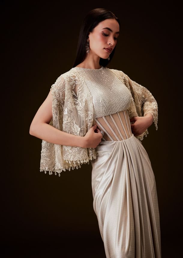 Off White Corset Gown With Sheer Waistline And Embroidered Cape Off White Corset Gown With Sheer Waistline And Embroidered Cape