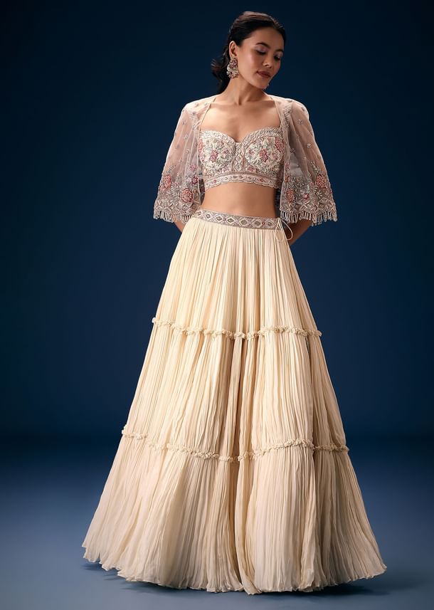 Off White Tiered Lehenga With Embroidered Corset Blouse And Embroidered Cape