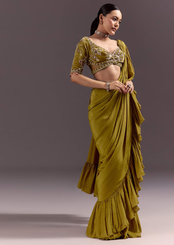 Olive Green Velvet Saree With Frilled Pallu And Heavy Embroidered Blouse Olive Green Velvet Saree With Frilled Pallu And Heavy Embroidered Blouse