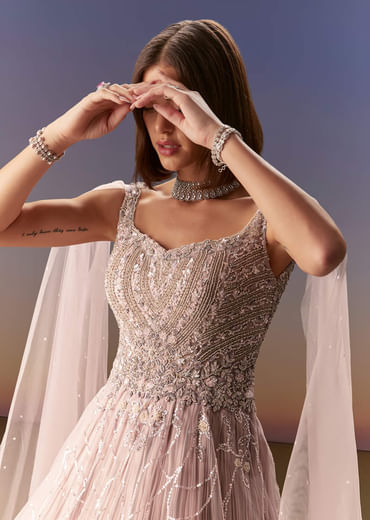 Pastel Pink Gown With Sheer Cape Drape And Heavy Embroidery