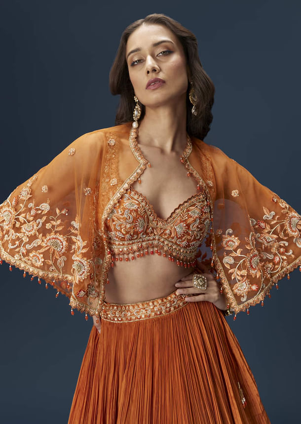 Rust Orange Embroidered Lehenga With Dramatic Cape And Blouse Rust Orange Embroidered Lehenga With Dramatic Cape And Blouse