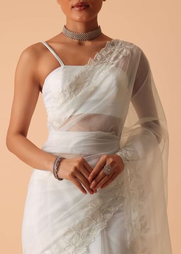 White Saree In Organza With Floral Motif Border And Unstitched Blouse Piece White Saree In Organza With Floral Motif Border And Unstitched Blouse Piece