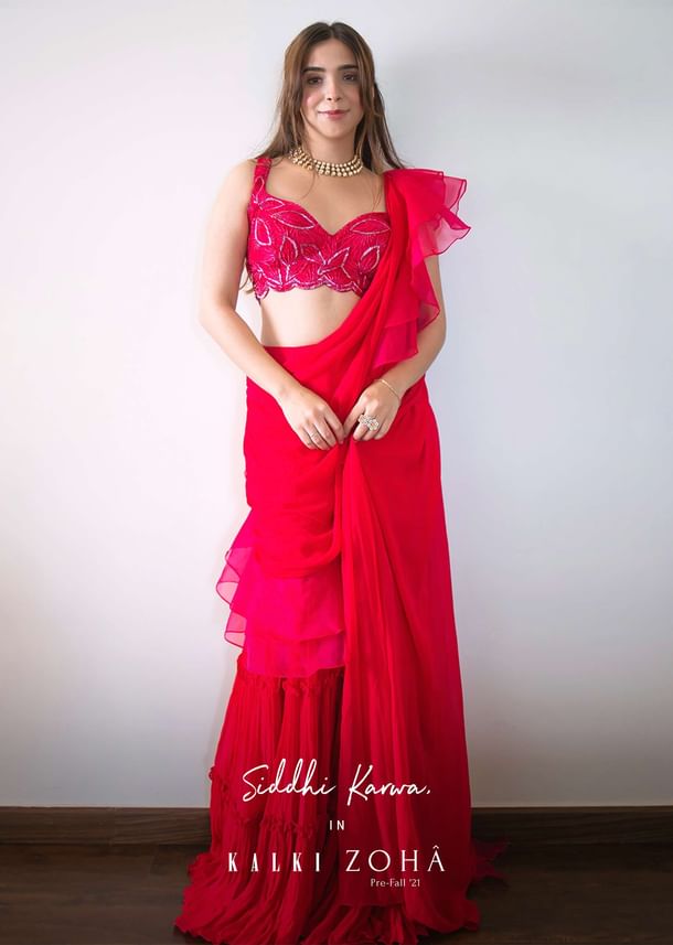 Hot Pink Crop Top Sharara Suit With An Attached Ruffle Draped And An Hand Embroidered Leaf Motifs
