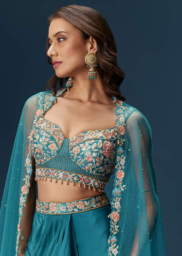 Teal Blue Dhoti Skirt Set With Embroidered Blouse And Net Dupatta Teal Blue Dhoti Skirt Set With Embroidered Blouse And Net Dupatta