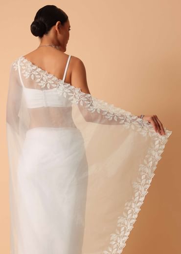 White Saree In Organza With Floral Motif Border And Unstitched Blouse Piece White Saree In Organza With Floral Motif Border And Unstitched Blouse Piece
