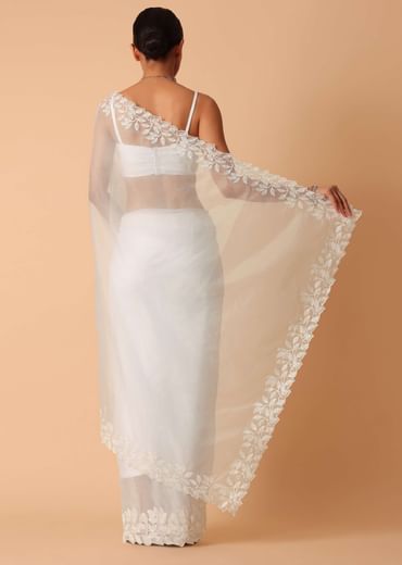 White Saree In Organza With Floral Motif Border And Unstitched Blouse Piece White Saree In Organza With Floral Motif Border And Unstitched Blouse Piece